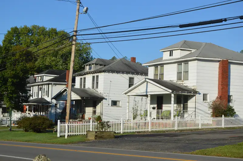 White frame houses with a picket fence along State Route 139 in Rubyville, Ohio